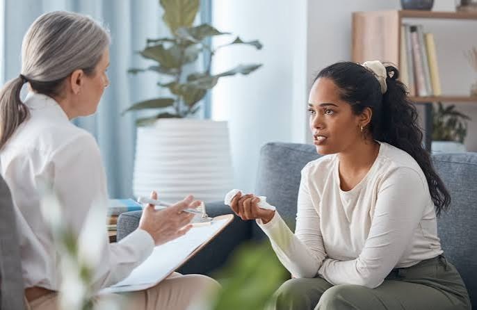 A therapist in conversation with a young woman